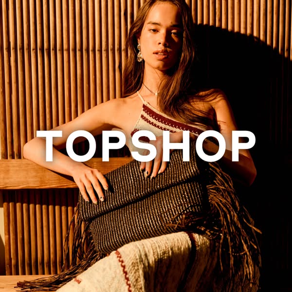 This ad for Topshop features a model sitting on a wooden bench with a woven clutch, promoting the brand's fashion an