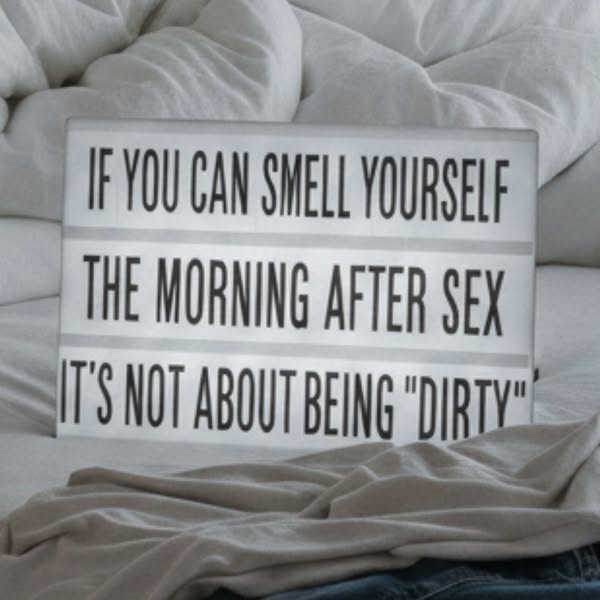This ad presents a humorous message about body odor, formatted on a light box.