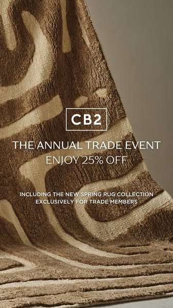 This ad promotes the CB2 Annual Trade Event, offering 25% off, including on the new Spring Rug Collection, exclusively f