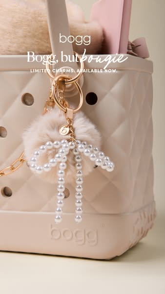 This ad showcases a Bogg Bag with a charm attached to it.