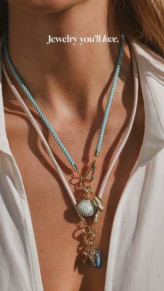 This image ad showcases a close-up of a woman wearing two layered necklaces.