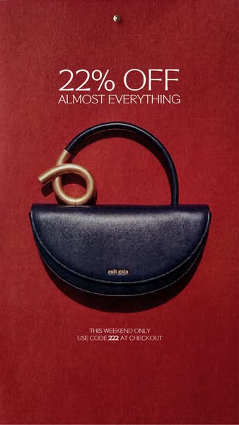 This is a static image ad promoting a discount on Cult Gaia products. The ad features a dark blue purse on a dark red ba