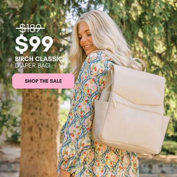 This ad features a light-skinned woman wearing a floral dress with a diaper bag slung over her shoulder and a sale price