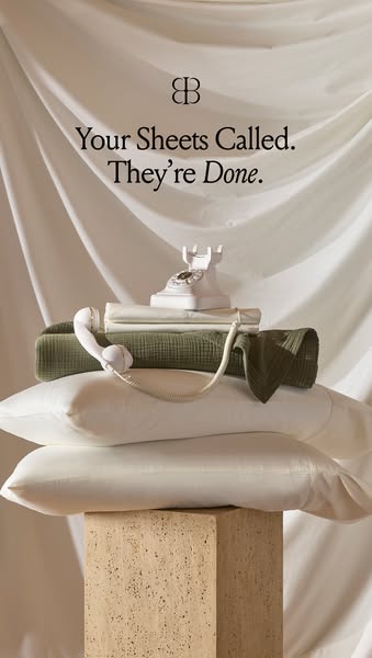 This ad showcases a stack of bedsheets and pillows, using a vintage telephone as a creative visual element. The headline