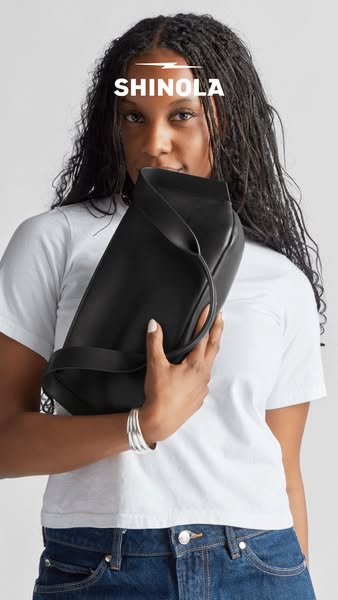 This ad showcases a woman holding a Shinola leather bag.
