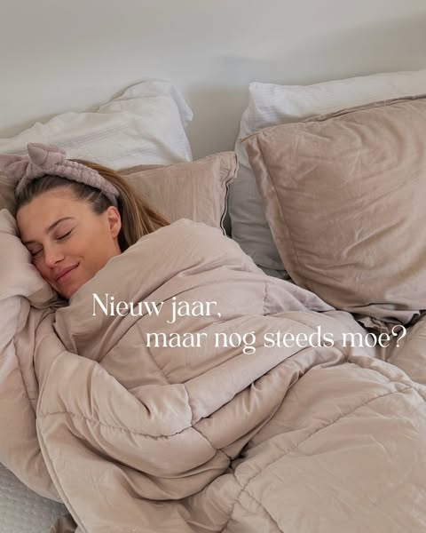 This image ad features a person in bed under the covers. The ad asks if the viewer is still tired, even in the new year.
