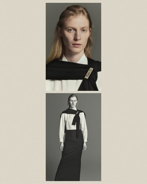A high fashion ad featuring a woman in a long black skirt and white blouse, accessorized with a black scarf held by a de