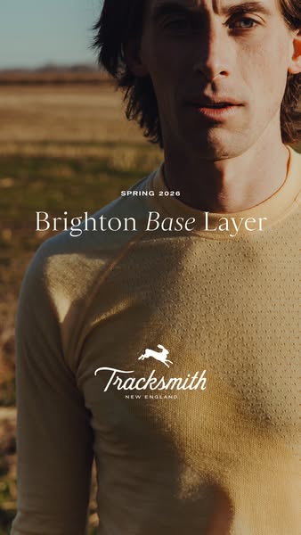 A close-up shot of a man outdoors wearing the Brighton Base Layer, with the brand's logo displayed on the shirt.