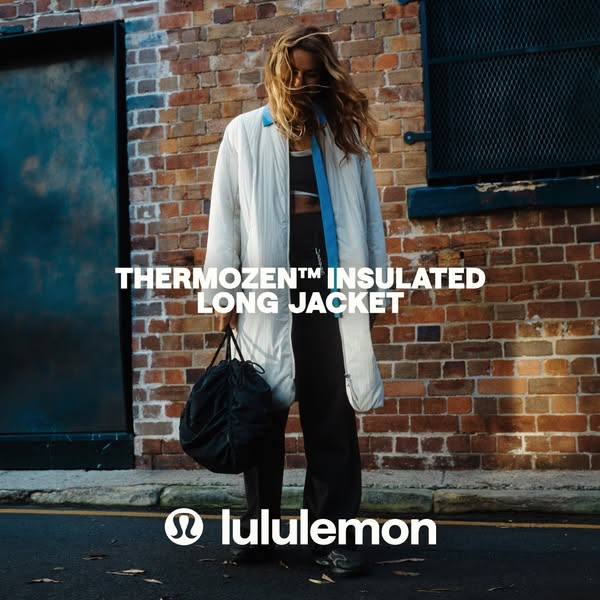 The ad showcases the Lululemon Thermozen insulated long jacket. It is a full shot of a person on a city street wearing t