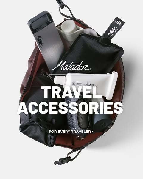 A product-focused image showcasing the Matador travel accessories line. The ad features a variety of travel-sized produc