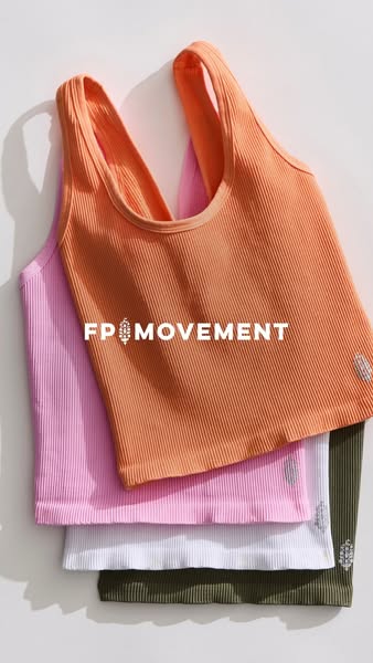 This image ad features a stack of FP Movement ribbed tank tops in an array of colors. The ad focuses on showcasing the t