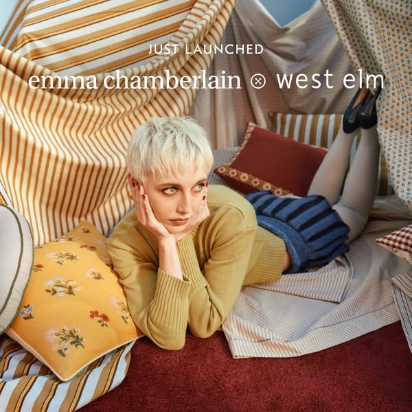 This ad promotes a new design collaboration between Emma Chamberlain and West Elm. The ad shows Emma Chamberlain laying 