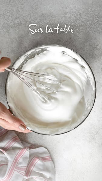 This ad shows someone whisking what appears to be egg whites or cream in a clear bowl. The brand logo is included in the