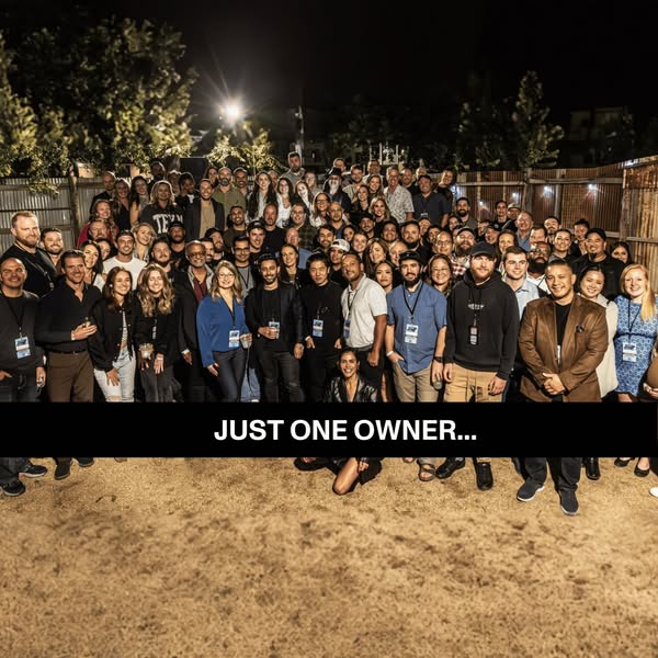 This image ad showcases a large group of people standing in a group photo with a black bar layered on the image with the
