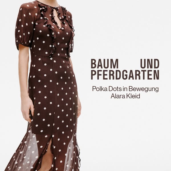This image ad showcases Baum und Pferdgarten's Alara Kleid dress, emphasizing its polka dot design and elegant style