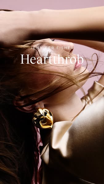 This ad showcases Jennifer Fisher's 'Hearthrob' earrings, emphasizing their design and luxury appeal through