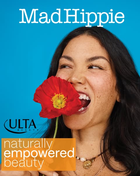 An image ad for Mad Hippie beauty products that is sold in Ulta Beauty stores, features a woman holding a red flower to 