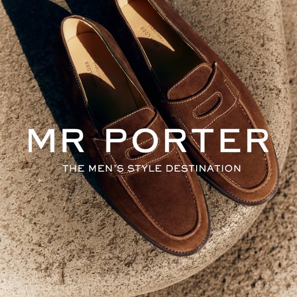 This image ad for Mr. Porter features a close up shot of a pair of brown suede John Lobb loafers placed on a rock, with