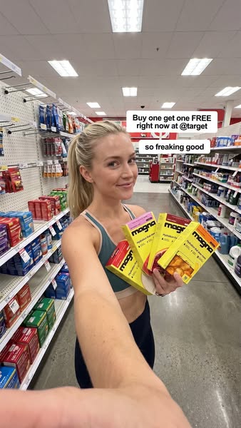 A female influencer is in a Target store holding up four boxes of hydration fuel. The ad emphasizes that it is buy one g