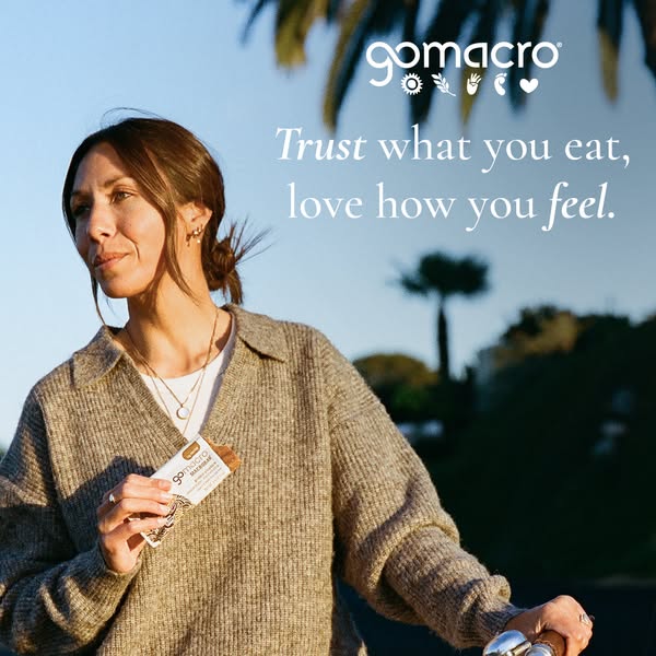 A woman is standing outside with a GoMacro bar in her hand. The ad aims to build trust by speaking to the consumer about