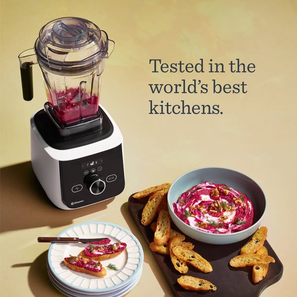 This ad showcases a Vitamix blender in a high-end kitchen setting. The blender is shown making a beet dip, which is then
