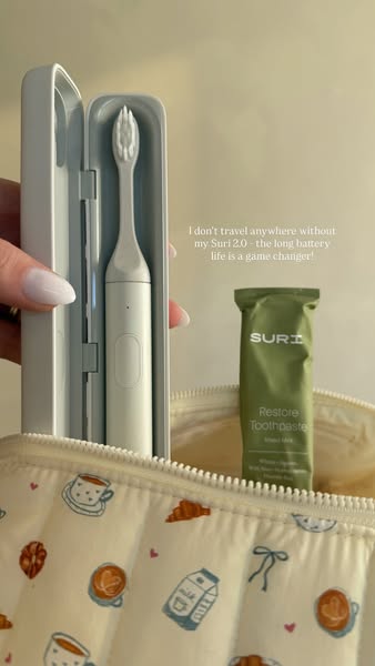 The ad showcases a Suri 2.0 toothbrush and Restore toothpaste inside of a travel bag. A testimonial from a user mentions