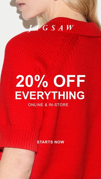 This ad for Jigsaw features a close-up of a fair-skinned person wearing a red ribbed sweater or top. The ad is promoting