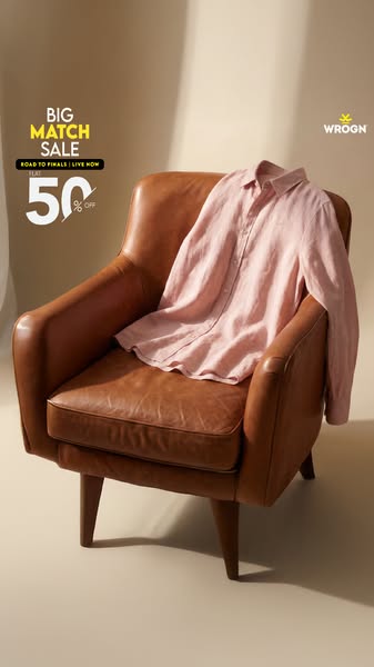 This ad features a light pink dress shirt draped over a brown leather chair. The ad promotes a sale event, which is name