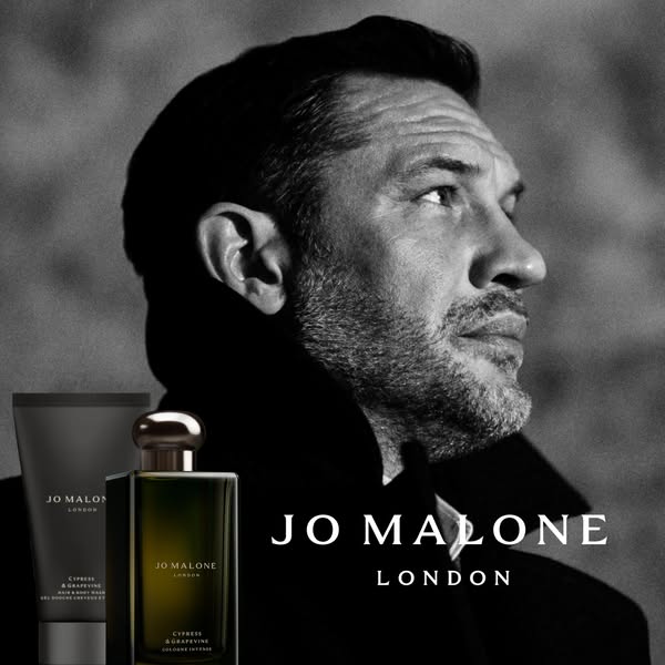 A black and white image ad for Jo Malone London featuring Tom Hardy and their Cypress & Grapevine product line.