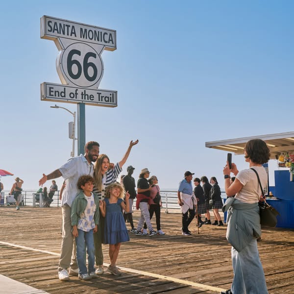 This image ad shows a family taking a picture at the Santa Monica Pier with the Route 66 sign in the background.