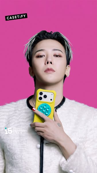 This ad features a person holding a bright yellow Casetify phone case in front of a pink background. The text promotes C