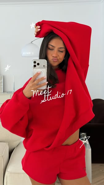 This ad features a woman showing off a matching Studio 17 red sweatsuit. The ad is designed to feel organic and native t