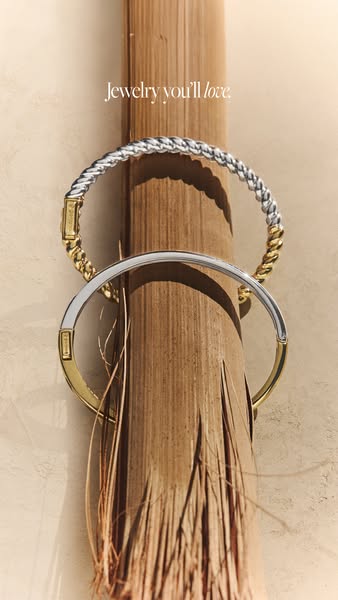 This image ad showcases two-tone metal bracelets with a tagline that promotes their desirability.