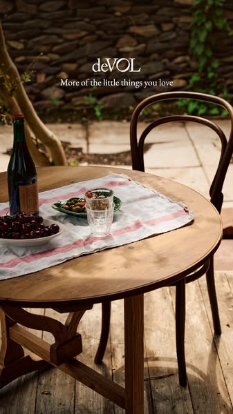 An inviting image of a table set with cherries, olives, and wine alongside the text, “More of the little things you love