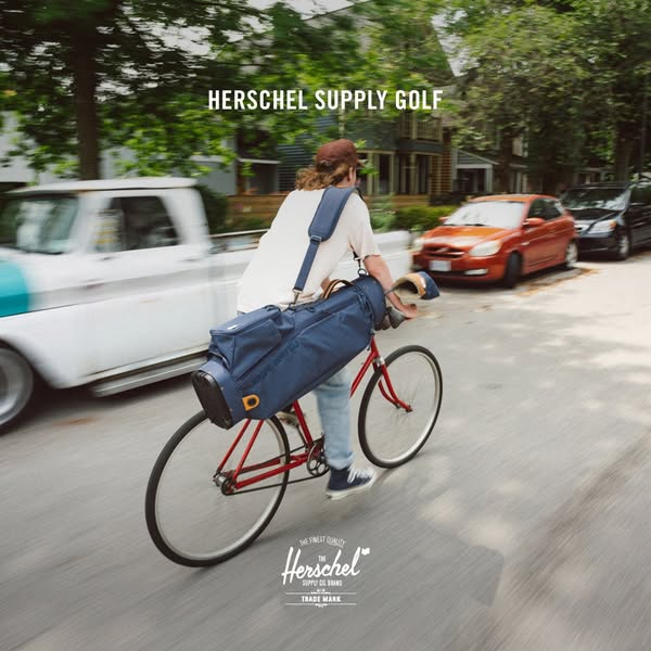 This ad features a man riding a bike with a Herschel golf bag. The image is promoting Herschel's golf supply line.