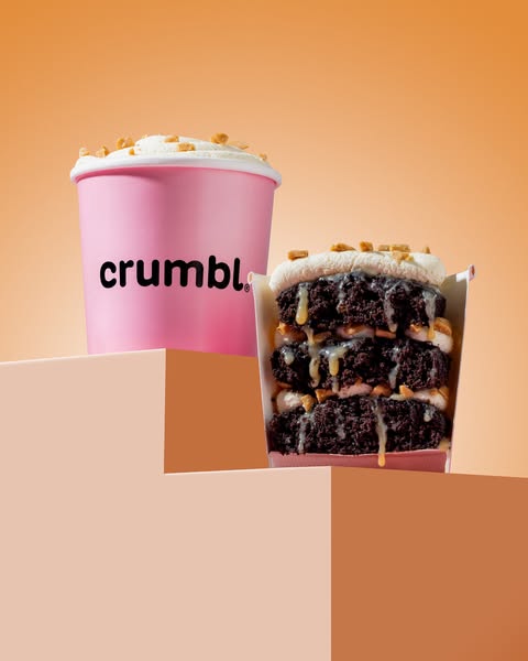 This image ad showcases Crumbl's offerings, including the cream-topped Crumbl shake and a stacked cookie dessert.