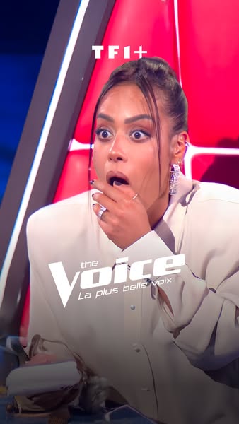 An ad showcasing a woman's surprised reaction. The ad promotes "The Voice" television show.