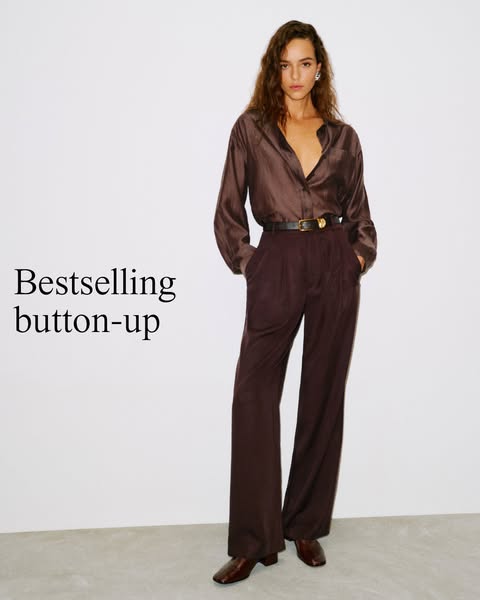This image ad features a woman wearing a satin button-up shirt and matching pants. The text overlay highlights the shirt