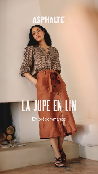 This ad features a woman leaning against a wall wearing a linen skirt by ASPHALTE. The skirt is currently available for 