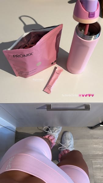 The ad features a pink-themed collection of Promix supplement products, including an open bag of electrolyte drink mix, 