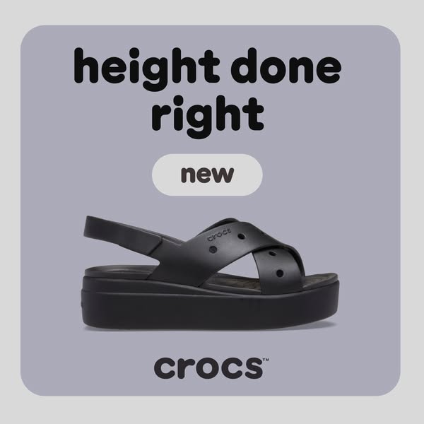 This ad features a single product shot of black Crocs platform sandals against a purple background. The text emphasizes