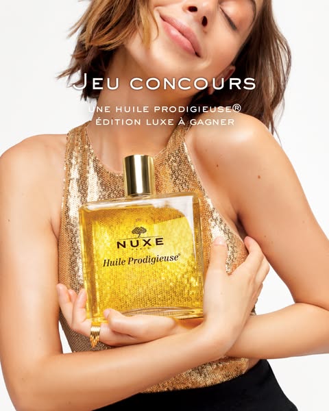 This ad features a woman holding a bottle of Nuxe Huile Prodigieuse oil. The ad promotes a sweepstakes opportunity to wi