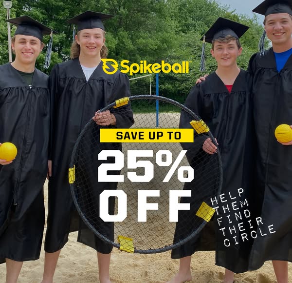This image ad showcases four young men wearing graduation gowns on a beach holding a Spikeball net and ball, promoting a