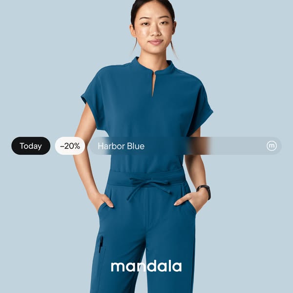 This is a static image ad for Mandala brand scrubs. A woman is modeling a set of scrubs in the color 'Harbor Blue