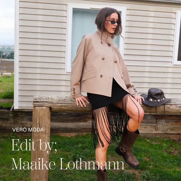 This Meta image ad showcases a woman in an outdoor setting, wearing a stylish jacket and skirt from the Vero Moda 'E