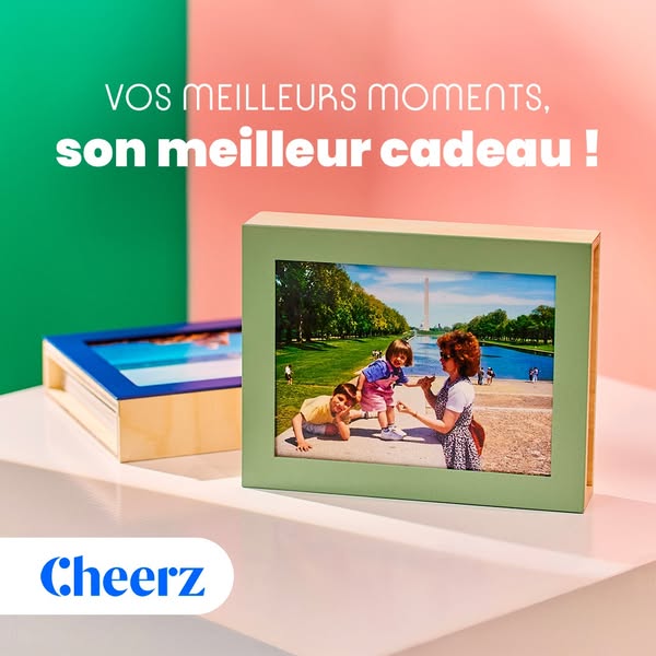 The ad features a light green and tan photo frame and a blue and tan box with a photo inside. The background is pink and