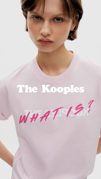 This ad features a close up shot of a woman wearing a light pink t-shirt with white and pink text over the chest. The ad
