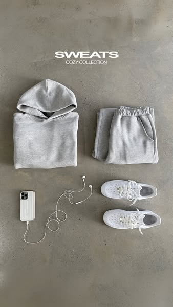 This image ad features a laid-flat gray sweatsuit, white sneakers, an iPhone, and wired headphones on a gray background.