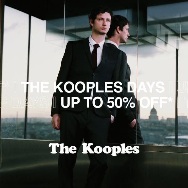 This image ad for The Kooples promotes a sale. It features a man in a black suit standing in front of a mirrored window 
