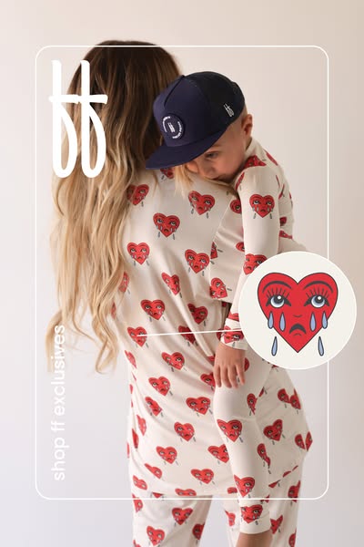 This image ad features a mom holding her child, both dressed in pajamas with a red heart design. The ad showcases "